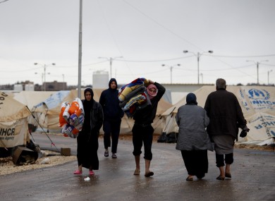 Syrian refugees carry their belongings at Zaatari refugee camp, near the Syrian border in Mafraq, Jordan.