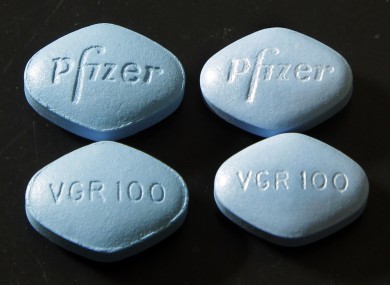 Fake Viagra pills (top and bottom left) beside real ones (top and bottom right)