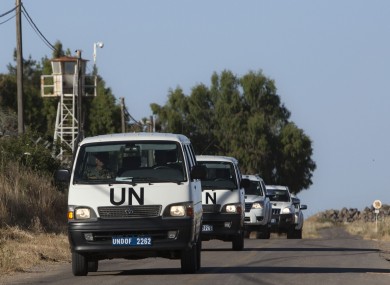 UN vehicles drive into a UN base near the Quneitra crossing between the Israeli-controlled Golan Heights and Syria