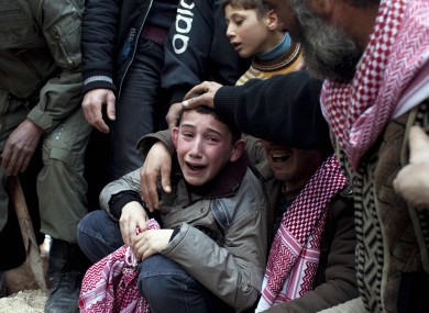 A Syrian boy mourns his father who was killed by a Syrian Army sniper in Idlib, north Syria last year.