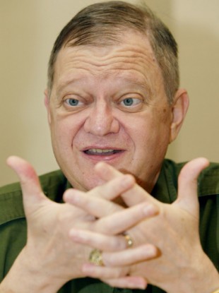 Tom Clancy, hawkish master of military thrillers, gestures during an interview. (File photo)