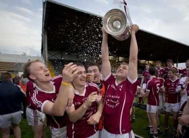 Clara's Tom Ryan celebrates with teammates after winning the Tom Walsh Cup.