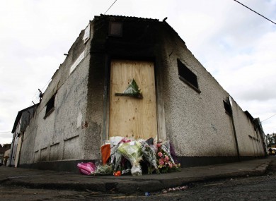 Flowers laid at the site of the factory fire which claimed the lives of the two firefighters.