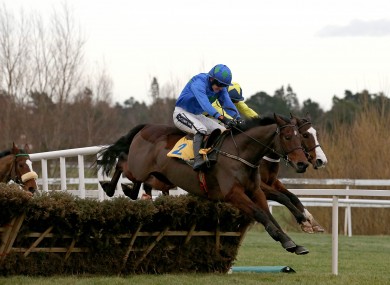 Hurricane Fly ridden by Ruby Walsh clears the last fence on his way to winning.