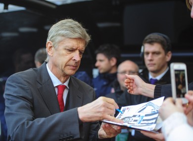 Arsenal boss Arsene Wenger signs autographs before the win over Newcastle.