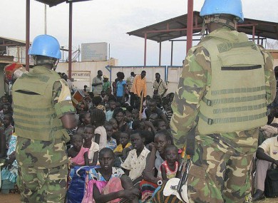 United Nations soldiers stand guard as civilians gather at the compound of the United Nations Mission in the Republic of South Sudan.