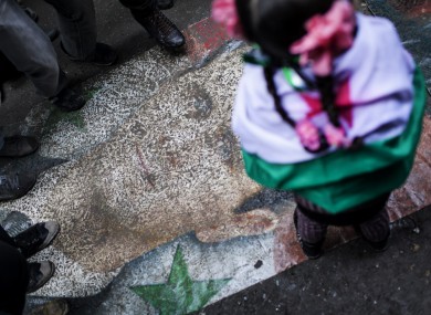Syrians stomp on a portrait during a demonstration in the neighborhood of Bustan Al-Qasr, Aleppo (File photo)