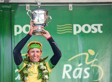 Overall race winner Clemens Fankhauser of Tirol Cycling Team UCI Continental Team Austria lifts the trophy.